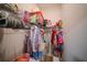 Organized walk-in closet with hanging racks and shelving for clothing storage at 9863 Summerlake Groves St, Winter Garden, FL 34787