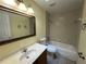 Bathroom with tiled walls, a shower-tub combo, and a mirrored vanity at 9923 Dean Acre Dr, Orlando, FL 32825
