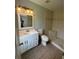 Bright bathroom with tiled shower, a modern vanity, and neutral color palette at 9923 Dean Acre Dr, Orlando, FL 32825