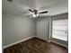 A cozy bedroom featuring wood floors, a ceiling fan, a window and a closet at 9923 Dean Acre Dr, Orlando, FL 32825