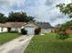 Charming single-story home featuring a well-maintained lawn, driveway, and an attached one-car garage at 9923 Dean Acre Dr, Orlando, FL 32825