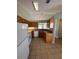 Bright kitchen featuring wood cabinets, laminate countertops, white appliances and tiled floor at 9923 Dean Acre Dr, Orlando, FL 32825