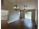 Inviting living room featuring wood-look floors, large windows, a modern ceiling fan and decorative chandelier at 9923 Dean Acre Dr, Orlando, FL 32825