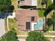 Aerial view of the property featuring a pool and solar panels at 10018 Chesham Dr, Orlando, FL 32817