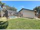 View of the screen-enclosed pool and grassy backyard at 10018 Chesham Dr, Orlando, FL 32817