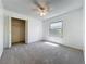 Carpeted bedroom featuring a ceiling fan, a large closet, and a window at 10018 Chesham Dr, Orlando, FL 32817
