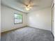 Carpeted bedroom featuring a ceiling fan, one window, and a closet at 10018 Chesham Dr, Orlando, FL 32817