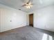 Carpeted bedroom featuring a ceiling fan, a closet, and a white door at 10018 Chesham Dr, Orlando, FL 32817
