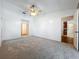 A spacious carpeted bedroom with a ceiling fan, and access to two closets at 10018 Chesham Dr, Orlando, FL 32817