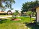 Manicured front yard with a view of the neighborhood street at 10018 Chesham Dr, Orlando, FL 32817