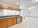 Open kitchen featuring granite countertops, stainless steel dishwasher, and view into the sunny living spaces at 10018 Chesham Dr, Orlando, FL 32817
