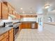 Bright kitchen featuring wood cabinets, stainless steel appliances, and a view of the pool at 10018 Chesham Dr, Orlando, FL 32817
