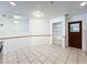 Bright eat-in kitchen area with tile floors, pantry, and view into the main kitchen area with modern appliances at 10018 Chesham Dr, Orlando, FL 32817
