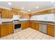 Updated kitchen with stainless steel appliances, granite counters, tile backsplash, and ample cabinet storage at 10018 Chesham Dr, Orlando, FL 32817