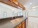 Bright kitchen featuring stone countertops, modern appliances, and a view into the inviting living room at 10018 Chesham Dr, Orlando, FL 32817