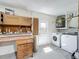 Functional laundry area equipped with a washer, dryer, and storage, making laundry chores convenient at 10018 Chesham Dr, Orlando, FL 32817