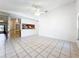 Spacious living room with tile flooring, open to the kitchen, offering a comfortable and bright living space at 10018 Chesham Dr, Orlando, FL 32817