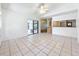 Light-filled living room showcasing tile floors, neutral paint, and seamless transition to the kitchen and dining area at 10018 Chesham Dr, Orlando, FL 32817