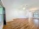 Large living room with hardwood floors, ceiling fan, and bright natural light at 10018 Chesham Dr, Orlando, FL 32817
