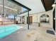 Covered patio with pool access, great for outdoor dining and relaxation with a view of the water at 10018 Chesham Dr, Orlando, FL 32817