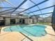 The pool is surrounded by a screened enclosure for enjoyable and comfortable outdoor living at 10018 Chesham Dr, Orlando, FL 32817