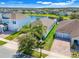 Stunning aerial view of the property with lush landscaping, a tranquil pond, and neat residential surroundings at 10091 Lovegrass Ln, Orlando, FL 32832