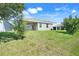 Spacious backyard with a well-maintained lawn and a covered patio at 10091 Lovegrass Ln, Orlando, FL 32832