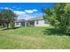 Expansive backyard featuring lush greenery and a view of the home's exterior at 10091 Lovegrass Ln, Orlando, FL 32832