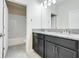 The bathroom features gray granite countertops with dark cabinets, and a tile shower and tub at 10091 Lovegrass Ln, Orlando, FL 32832
