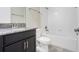 The bathroom features gray granite countertops with dark cabinets, and a white shower and tub at 10091 Lovegrass Ln, Orlando, FL 32832