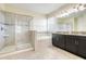 This bathroom features a tiled walk-in shower, soaking tub, and granite countertops with dark cabinets at 10091 Lovegrass Ln, Orlando, FL 32832