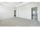 Spacious bedroom with neutral carpet, a tray ceiling, and an ensuite bathroom for convenience at 10091 Lovegrass Ln, Orlando, FL 32832