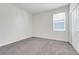 The bedroom features neutral carpet, a window with blinds, and white walls and closet at 10091 Lovegrass Ln, Orlando, FL 32832