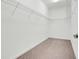 The walk-in closet features neutral carpet and white wire shelving at 10091 Lovegrass Ln, Orlando, FL 32832