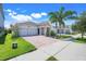 Charming single-Gathering home with a brick driveway, well-manicured lawn, and a two-car garage at 10091 Lovegrass Ln, Orlando, FL 32832