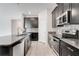 Well-lit kitchen with granite countertops, stainless steel appliances, and mosaic tile backsplash at 10091 Lovegrass Ln, Orlando, FL 32832