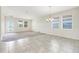 Bright living area with tile and carpet flooring, showcasing ample natural light and easy access to the backyard at 10091 Lovegrass Ln, Orlando, FL 32832