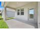 Covered patio with access door provides a space for outdoor relaxation at 10091 Lovegrass Ln, Orlando, FL 32832
