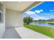 Enjoy outdoor living on the covered patio with a serene lake view at 10091 Lovegrass Ln, Orlando, FL 32832