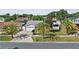 An aerial view of the home with palm trees, a two-car garage, and a well-maintained lawn at 109 Woodfield Ct, Sanford, FL 32773