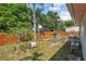 Backyard with a fenced pool area, mature trees, and well-kept lawn, offering privacy and outdoor enjoyment at 109 Woodfield Ct, Sanford, FL 32773