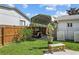Grassy backyard featuring a covered grilling area and vibrant flowering shrubs, perfect for outdoor gatherings at 109 Woodfield Ct, Sanford, FL 32773