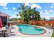 Backyard featuring a private pool surrounded by lush landscaping and ample seating at 109 Woodfield Ct, Sanford, FL 32773