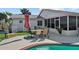Backyard showcasing a refreshing pool, a patio with dining set, and the home's exterior with a screened-in porch at 109 Woodfield Ct, Sanford, FL 32773