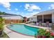 Backyard with a refreshing pool, patio furniture, and manicured landscaping for outdoor enjoyment at 109 Woodfield Ct, Sanford, FL 32773