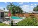 Relaxing backyard oasis featuring a sparkling pool, patio with dining set, and lush landscaping for outdoor enjoyment at 109 Woodfield Ct, Sanford, FL 32773