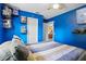 Blue bedroom featuring shelving, a ceiling fan, and an open door to another room at 109 Woodfield Ct, Sanford, FL 32773