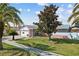 A charming single-story home with a well-manicured lawn and mature trees in a peaceful setting at 109 Woodfield Ct, Sanford, FL 32773