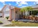 Inviting front porch with decorative accents, pink trim, and a well-maintained lawn at 109 Woodfield Ct, Sanford, FL 32773
