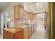 Kitchen boasting light wood cabinetry and stainless steel appliances adjacent to the dining area at 109 Woodfield Ct, Sanford, FL 32773